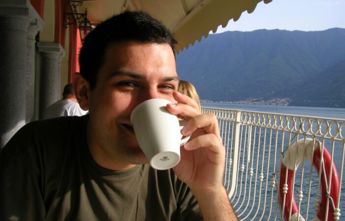 Business Coach Jacob Aldridge drinking coffee at Lake Como