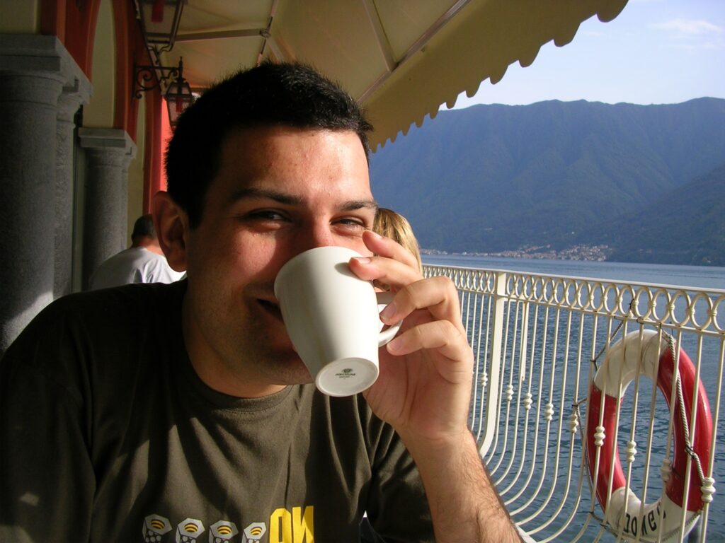 Business Coach Jacob Aldridge drinking coffee at Lake Como